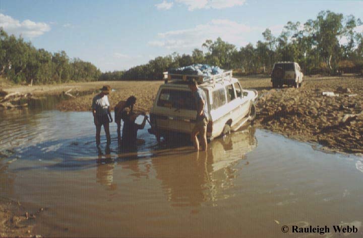 John Cugley getting bogged on the way to Old Napier Downs cave. We were a tad overloaded and John tried to help Brian out of the water and got well bogged himself. - 1996 - Kimberley